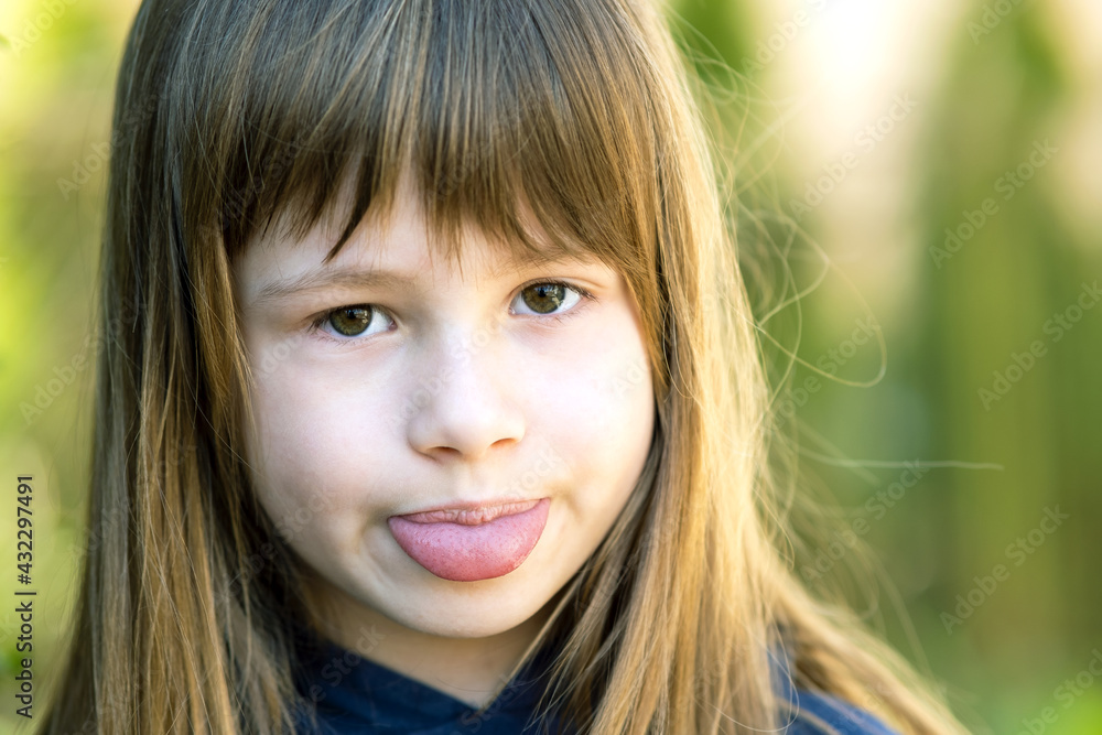 Close up portrait of cute girl showing tongue and looking at camera. Close up portrait of cute girl showing tongue and looking at camera.