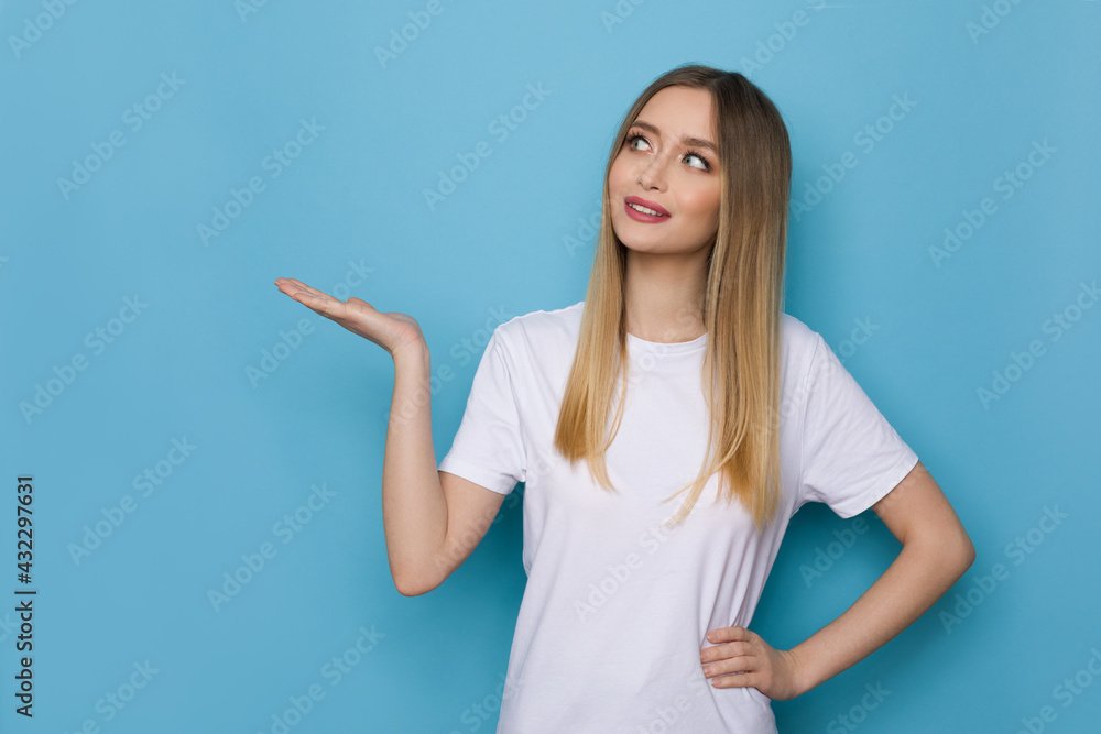 Young Woman Is Holding Hand Raised And Looking Aside Young Woman Is Holding Hand Raised And Looking Aside