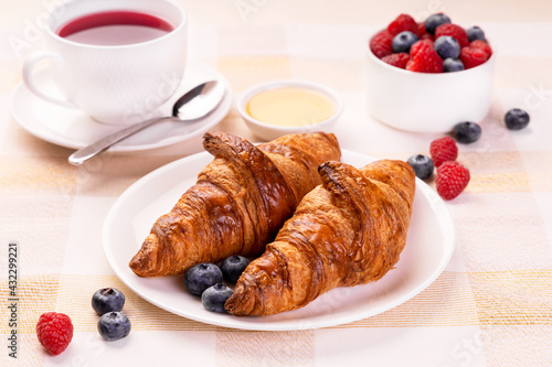 Fresh Baked Croissants Served On A Breakfast Table With Hot Fruit Tea Raspberry Honey And Blueberry.