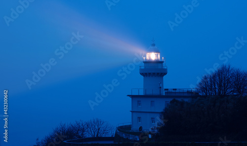 Lights in the lighthouse with fog at dawn, Igueldo, city of Donostia (San Sebastian) photo