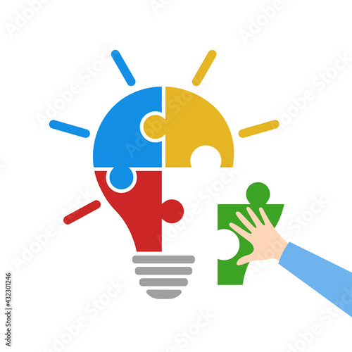 Light bulb idea concept. Hand putting one colorful jigsaw puzzle piece to collect bulb puzzle