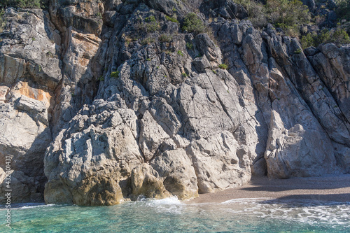 Small picturesque beach surrounded by rocks and clear turquoise water, Albania. Travel theme, beautiful nature