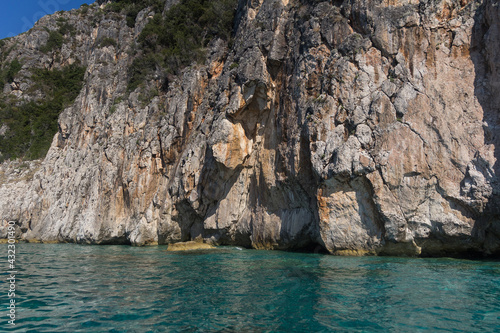 Picturesque rocks and blue shining sea, Albania. Travel theme, beautiful nature