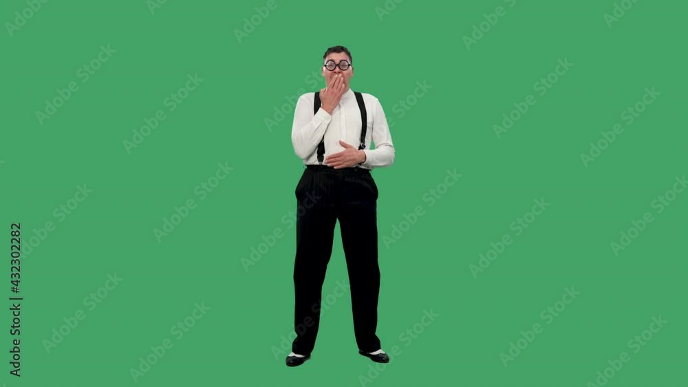 The man laughs loudly, holding his stomach with one hand, covering his mouth with the other. Portrait of a man in a white shirt with suspenders and glasses in the studio on a green screen. Slow motion The man laughs loudly, holding his stomach with one hand, covering his mouth with the other. Portrait of a man in a white shirt with suspenders and glasses in the studio on a green screen. Slow motion