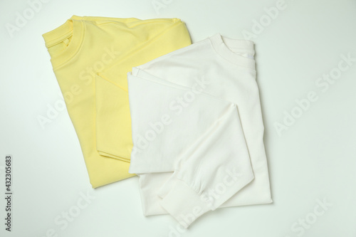 White and yellow sweatshirts on white background
