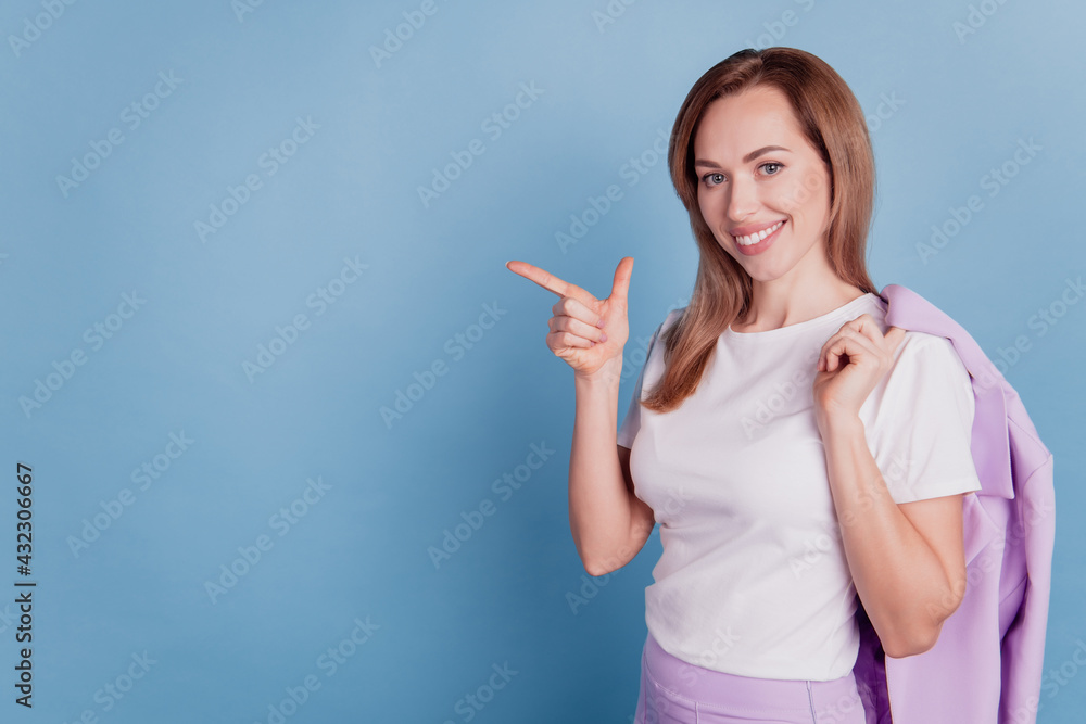Portrait of confident girl promoter point finger copy space isolated over blue background Portrait of confident girl promoter point finger copy space isolated over blue background