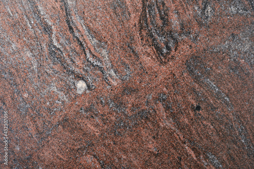 Brown, red, gray granite texture. Stone background. Polished natural granite slab. Rock texture.