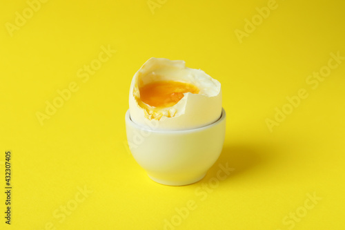 Tasty boiled egg on yellow background, close up