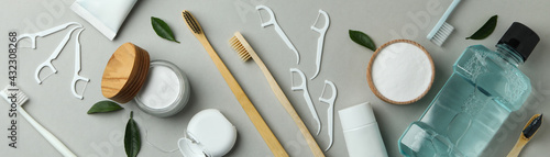 Oral care accessories on gray background, top view