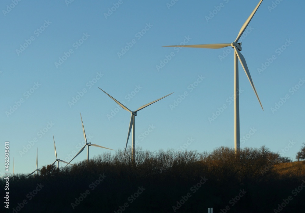 Upward shot of a row of windmills along the highway