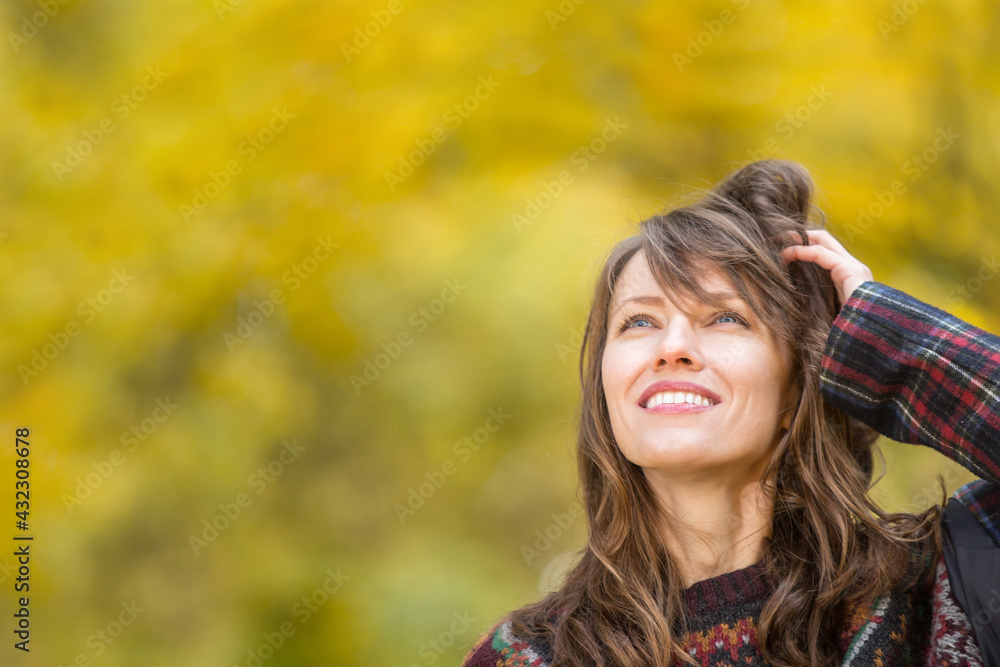 portrait of beautiful woman wearing sweater  in  autumn yellow park