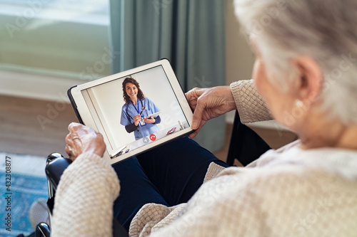 Doctor on video call with disabled senior patient photo