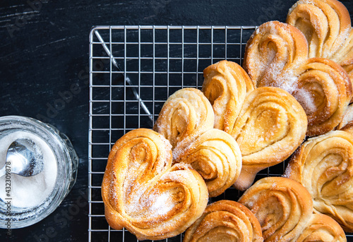 Homemade Palmier Puff Pastry. Delicious french palmier cookies with sugar on a cooling rack. Palmiers, elephant ear, puff pastry cookie