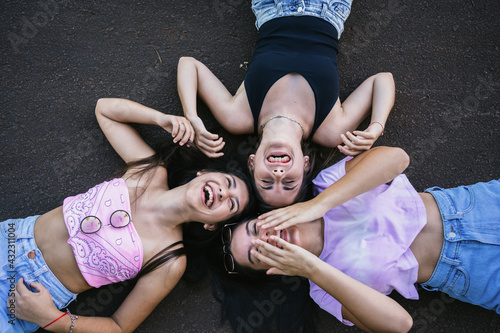 Cheerful girls lying in the open air.