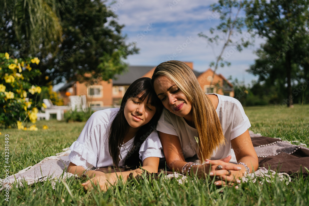 Portrait of mother and daughter lying down on a picnic day. Portrait of mother and daughter lying down on a picnic day.