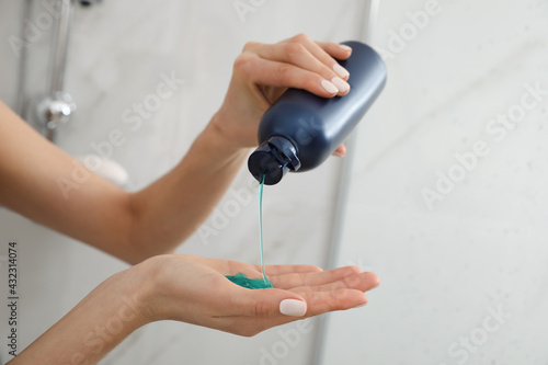 Obraz na plátně Young woman using gel in shower at home, closeup