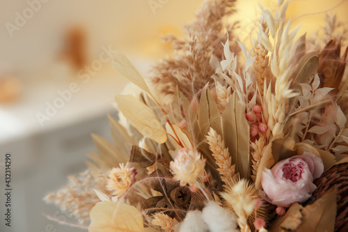 Fototapeta Naklejka Na Ścianę i Meble -  Bouquet of dry flowers and leaves on blurred background, closeup