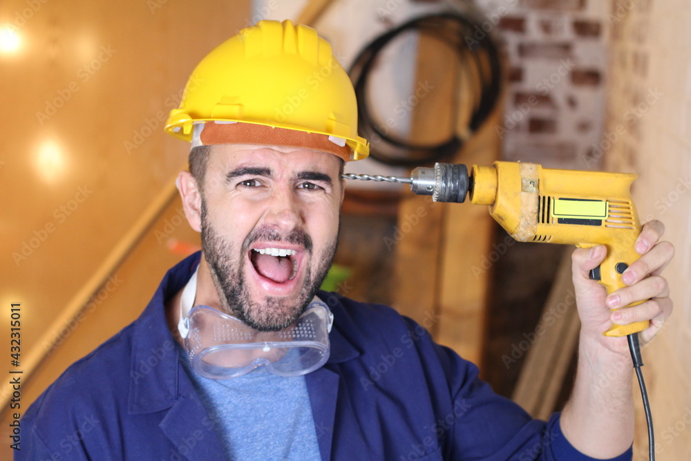 Anxious construction worker holding drill Anxious construction worker holding drill