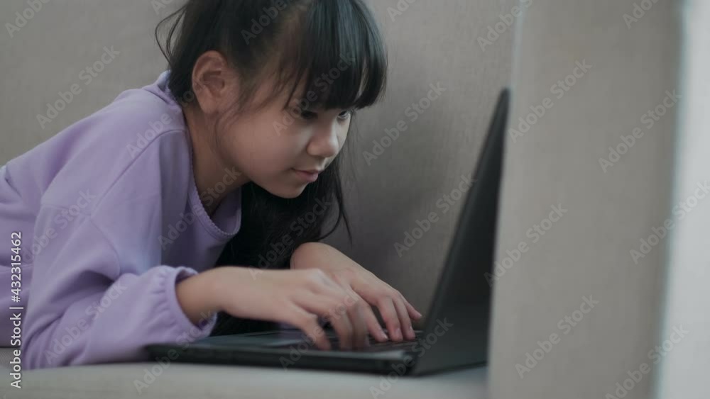 Teenager girl busy to learning looking a screen laptop And type the keyboard during a social distance after coronavirus crisis. online learning at home and new normal concept. Teenager girl busy to learning looking a screen laptop And type the keyboard during a social distance after coronavirus crisis. online learning at home and new normal concept.