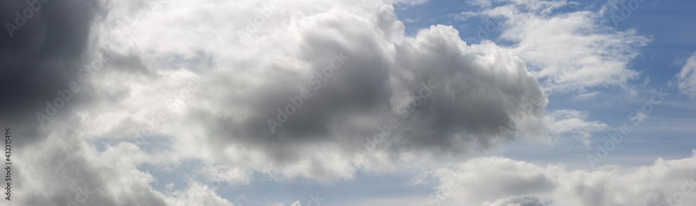 Panorama with well defined cumulus cloud chased by dramatic dark rain filled front in dramatic sky scenery landscape. Weather conditions and climate concept. Science backdrop. Panorama with well defined cumulus cloud chased by dramatic dark rain filled front in dramatic sky scenery landscape. Weather conditions and climate concept. Science backdrop.