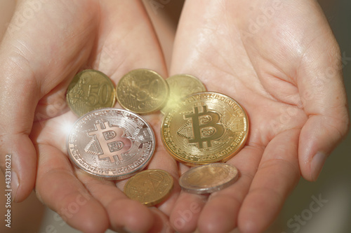 Abstract hand holding Bitcoin and Euro coins. The concept of digital currency for world banking and business investments.