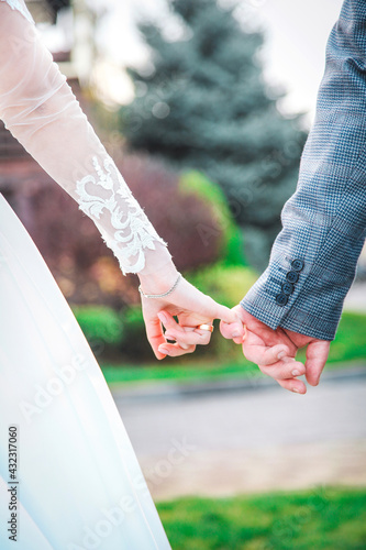 bride and groom holding hands