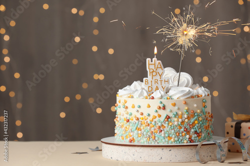 Photography Beautiful birthday cake with festive decor on white table