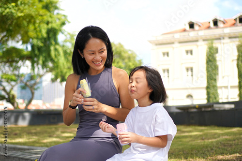 asian chinese child with mother in cloud nine after tasting ice cream