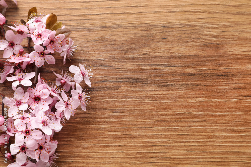 Blossoming spring tree branch on wooden table, flat lay. Space for text Blossoming spring tree branch on wooden table, flat lay. Space for text
