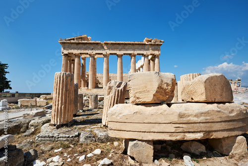 Parthenon temple on a bright day with blue sky. Panoramic image taken in Acropolis hill in Athens, Greece. Classical ancient Greek civilization landmark, famous place, panoramic travel background.