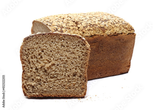 Integral rye bread loaf with seeds and slice isolated on white background