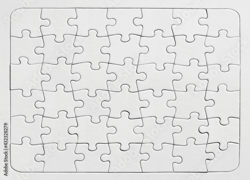 White jigsaw puzzle background. Overhead view with copy space.