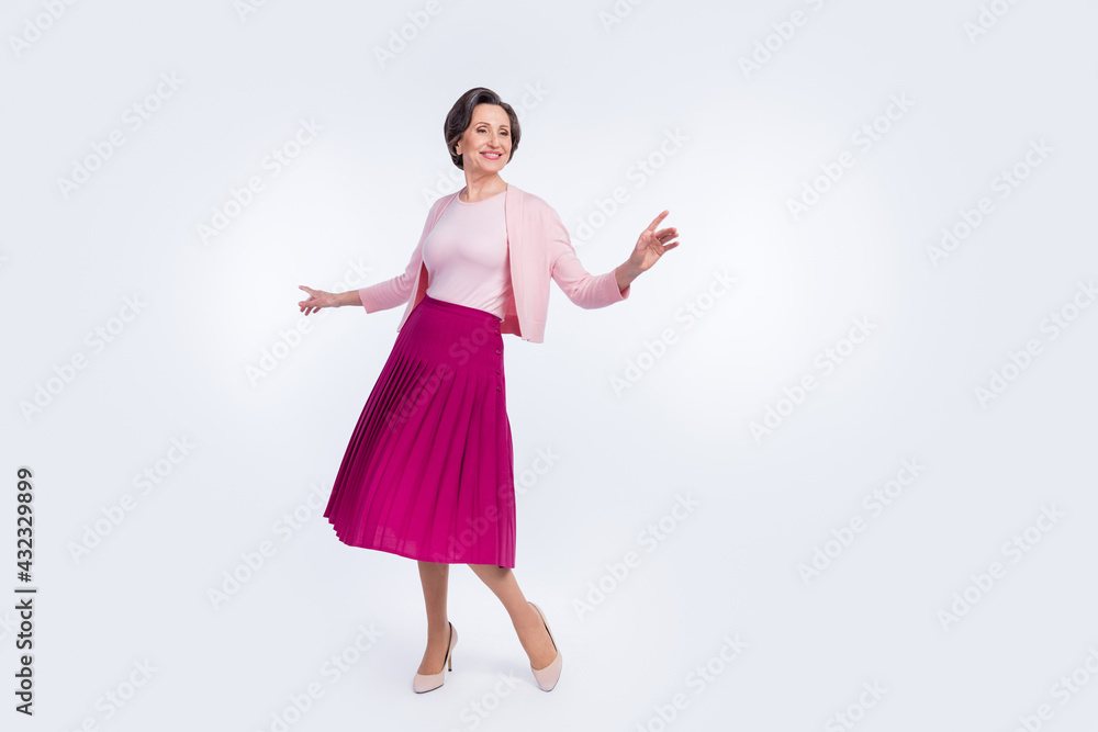 Photo of cute charming age woman dressed pink outfit dancing smiling isolated white color background Photo of cute charming age woman dressed pink outfit dancing smiling isolated white color background