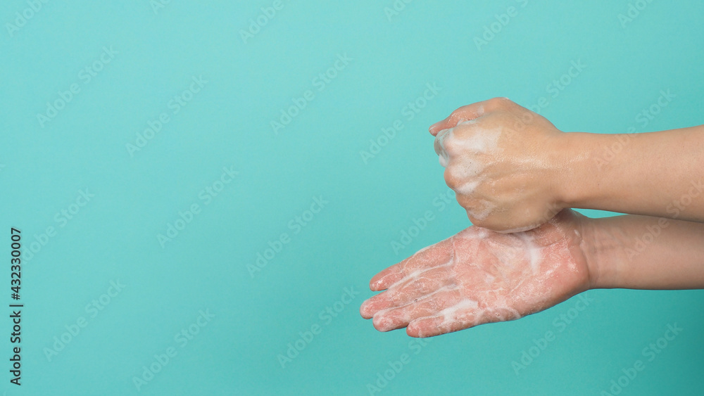 Hands washing gesture with foaming hand soap on mint green and Tiffany Blue background. Hands washing gesture with foaming hand soap on mint green and Tiffany Blue background.