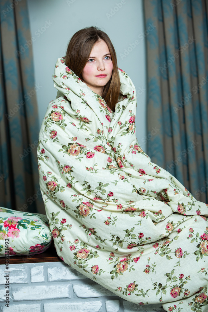 Fototapeta premium Young beautiful white woman awaking in light room. Relaxed woman lying in bed and drink tea. Good morning concept. Russian girl.