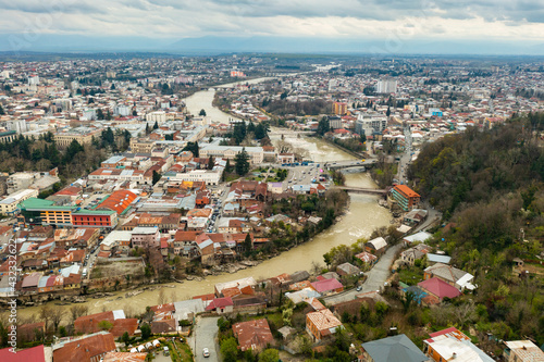 General aerial view of Kutaisi cityscape on banks of Rioni River in springtime, Imereti region, Georgia photo