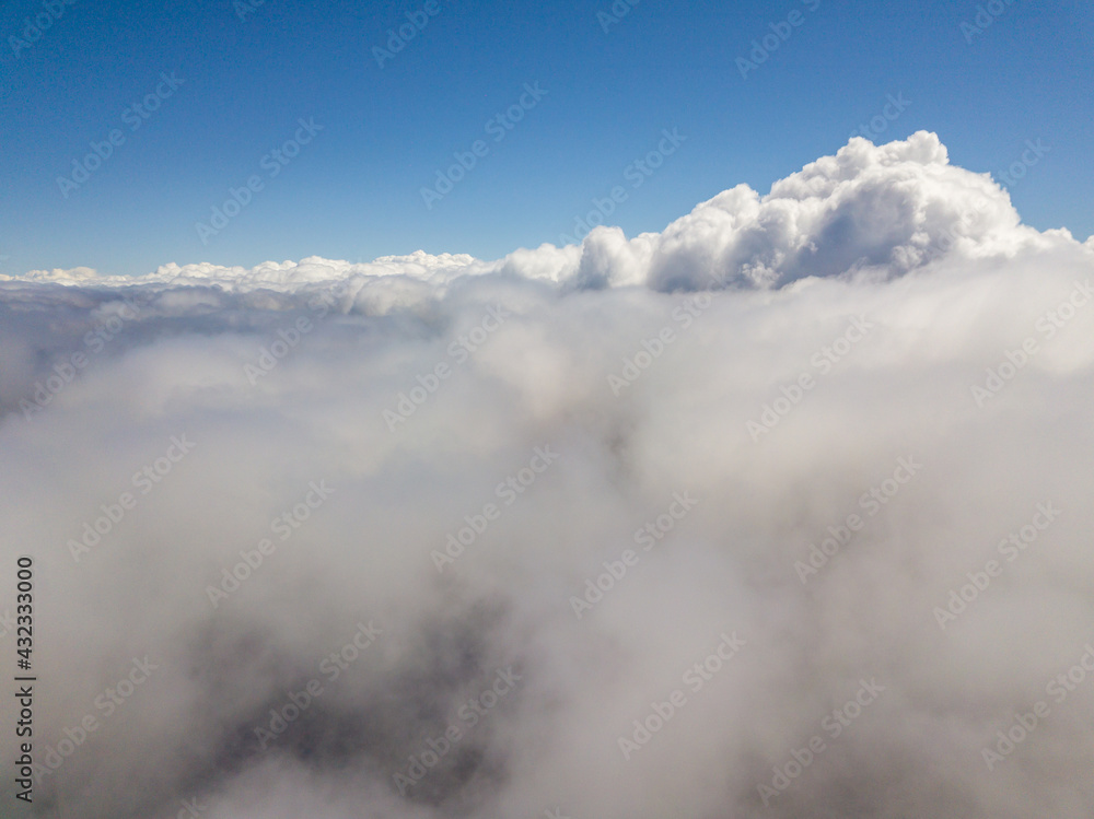 Flying in the clouds. Aerial high view.