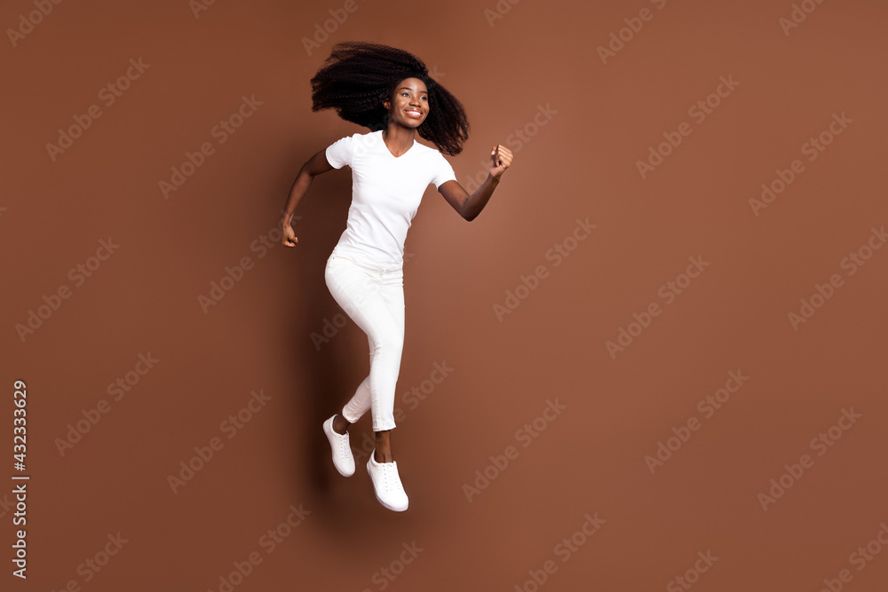 Full size profile portrait of carefree dark skin person hurry look empty space isolated on brown color background
