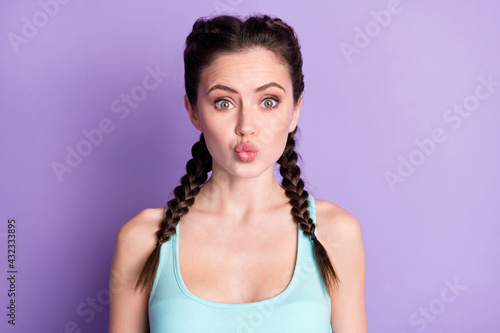 Portrait of nice funky attractive amorous girl sending air kiss isolated over violet purple color background
