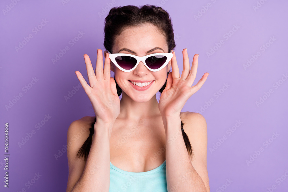 Close-up portrait of attractive cheerful girl touching specs good look isolated over violet purple color background