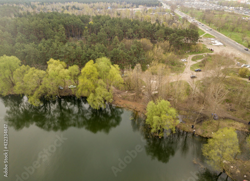 City lake shore in cloudy weather. Aerial drone view.