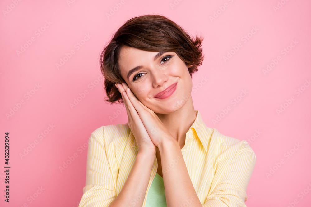 Photo of cute sweet young woman wear yellow shirt arms together cheek isolated pink color background Photo of cute sweet young woman wear yellow shirt arms together cheek isolated pink color background