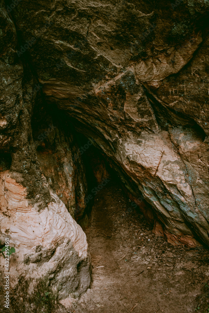 Small sandstone cave in Licu Langu sandstone cliffs in Latvia near Gauja river