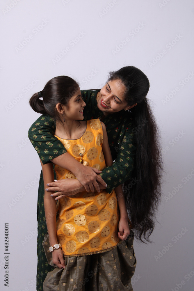 Indian mother daughter on white background. mothers day