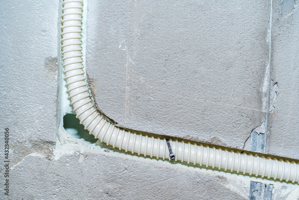 Installation of electrical wiring in a concrete wall using a corrugated