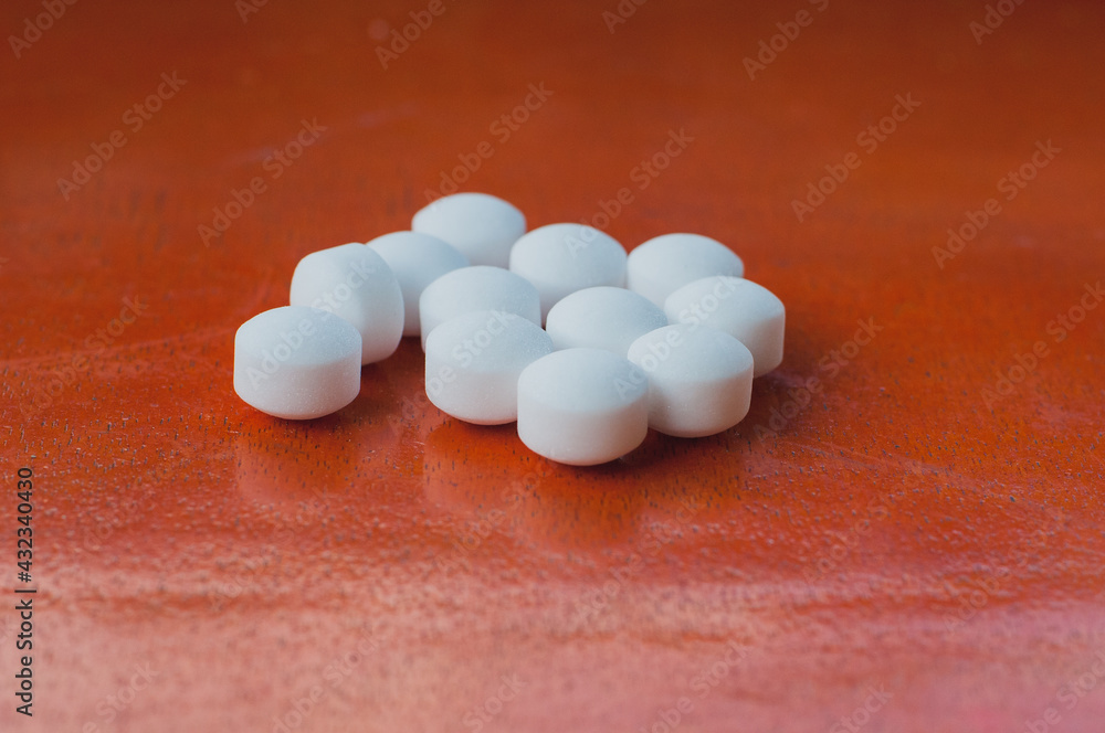 close-up white mothball or naphthalene over the wooden background close-up white mothball or naphthalene over the wooden background