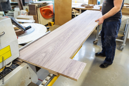 Furniture manufacturing. The process of applying pvc edging to veneered panels. Unrecognizable people. Selective focus