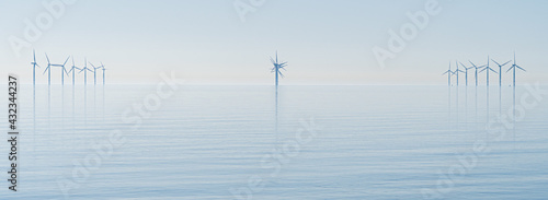 Offshore wind turbines generating renewable electricity and energy off the Essex clacton coast for eco backdrop, texture, wallpaper shiloutted against clear sky background