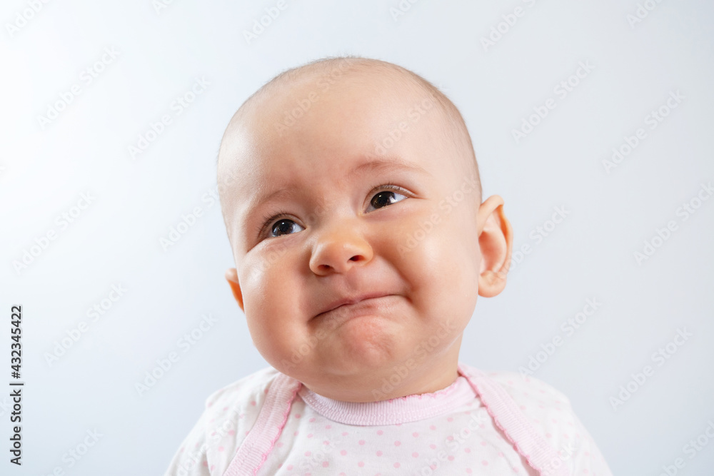Portrait of a sad newborn baby with an unhappy look