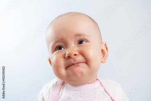 Portrait of a sad newborn baby with an unhappy look